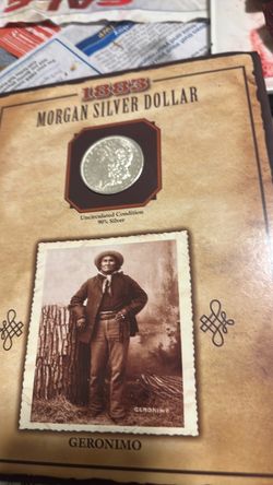 1883-O Morgan Silver Dollar – Geronimo Display  Vintage 1883 Morgan silver dollar with the “O” mint mark for New Orleans, presented in a decorative Ge