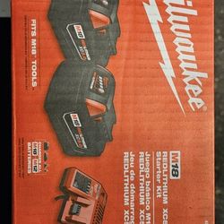 Two Milwaukee M18 5.0 Batteries And Charger