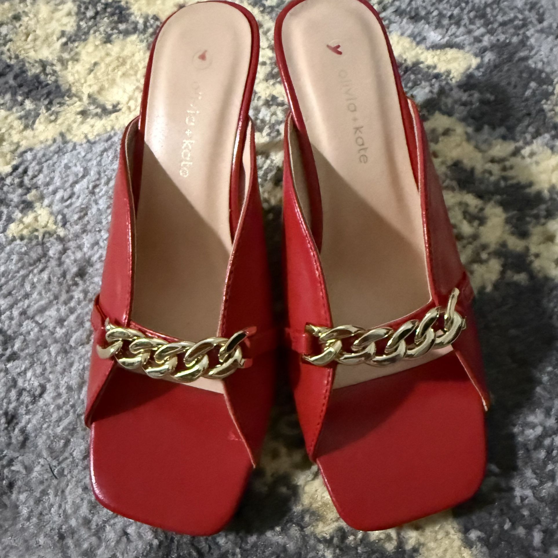 Olivia + Katie red faux leather square-toe block heel mules with a gold-toned chain