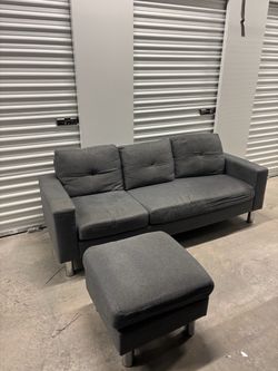 dark gray fabric three-seater sofa