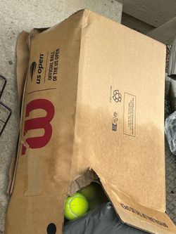 Box of used tennis balls
