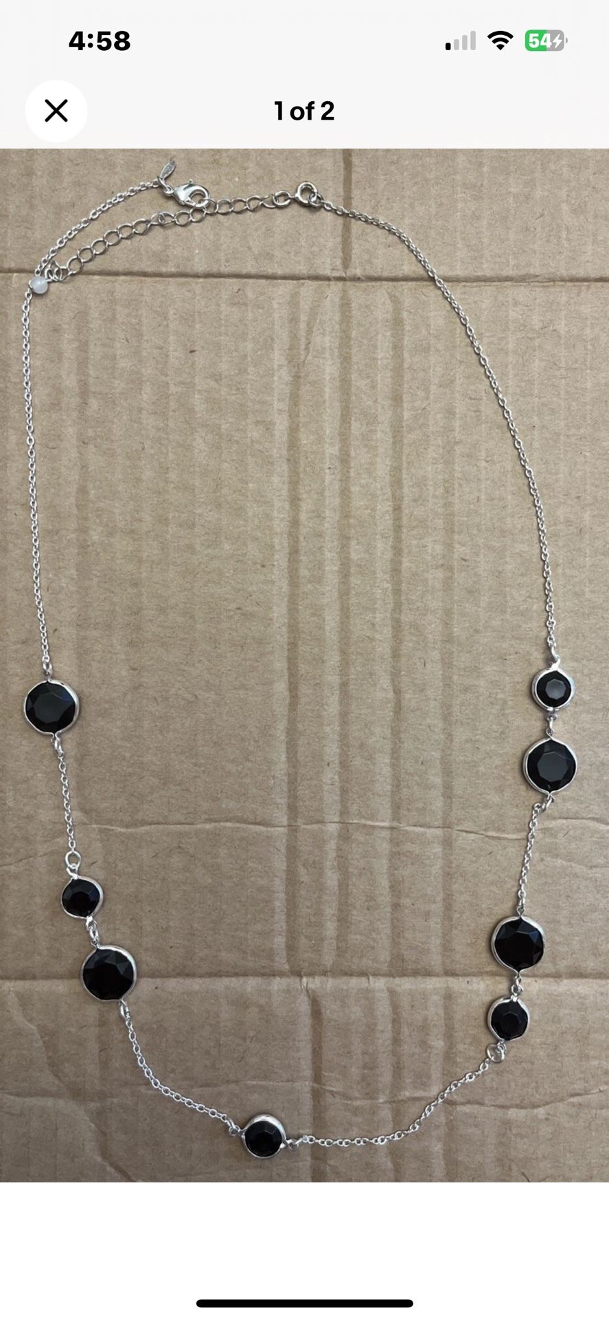 Silver toned necklace with black stones.