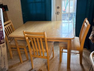 Selling a sturdy wood/oak-finish dining table set that comes with 4 matching chairs.