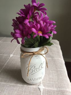 Distressed mason jar with silk flowers