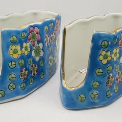 A pair of vintage blue floral enameled ceramic buffet silverware or utensil holders