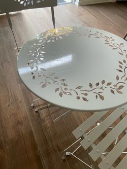 White bistro set; two chairs and table
