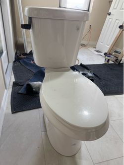 Toilet 12 in. Rough In 2-Piece 1.0 GPF/1.28 GPF Dual Flush Elongated Toilet in White, Seat Included/ toilet glacier bay