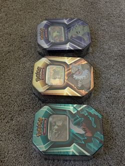 All three Triple Whammy Pokemon Tins