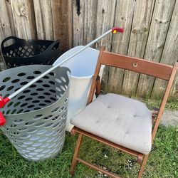 Two Beautiful Laundry Baskets, A Black And A Grey One Which Has A Little Cut.  Two Kitchen Trash  Cans, A Wooden Folding Chairs To Fold The Clothes.