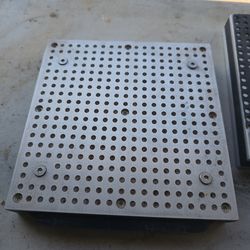 Vacuum hold down plate