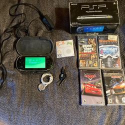 PSP with With Memory Card and Games.