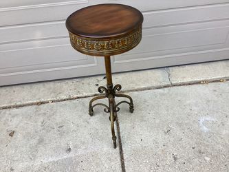 Plant stand / …table metal base wood top ornate base very expensive new like new .. 31 Tall …14 in. Diameter. This is a very nice stand / table