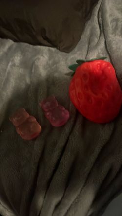 Two needoh gummy bear and one big squishy strawberry Two needles and one big squishy strawberry