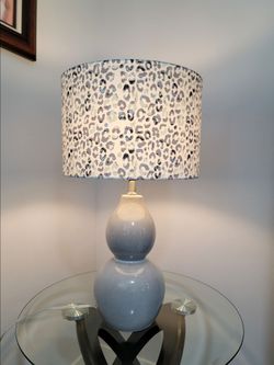 Table lamp featuring a large, double-gourd ceramic base in a blue-gray hue.