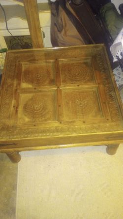 Wooden coffee table with glass top