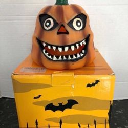 Halloween pumpkin candle with battery operated flicker lite inside. light shines through eyes nose and mouth