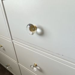 White Ikea Dresser with custom knobs. 