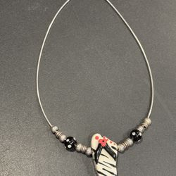 Sterling Silver necklace. Marked Italy .925. Nice statement piece w/ Ceramic Sandal plus Sterling & ceramic beads. 16” length.