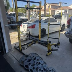 Bench press/squat rack with 7ft 45lbs bar plus 255lbs of Olympic weights and power tower