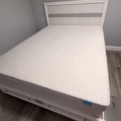 Queen size bed with mattress and topper