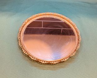 Vintage gold toned scrolled metal with gilded finish and ornate craftsmanship