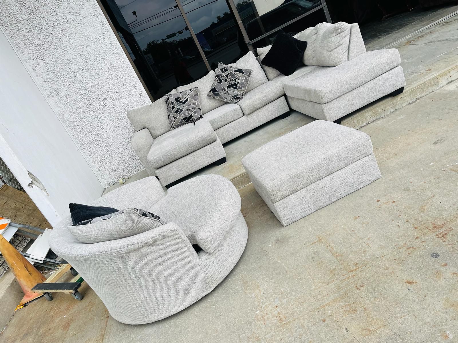 Grey fabric sectional with ottoman  And round swivel chaise