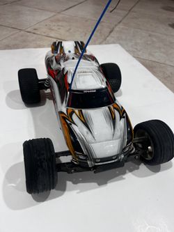 Older Traxxas Rustler, remote, charger, and batteries