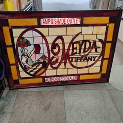 Customizable Meyda Tiffany stained glass window panel, often used as decorative wall art or signage for authorized dealers. This one is lamp and shade