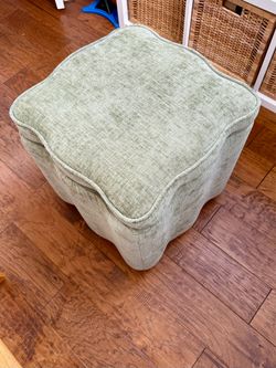 Small upholstered storage ottoman