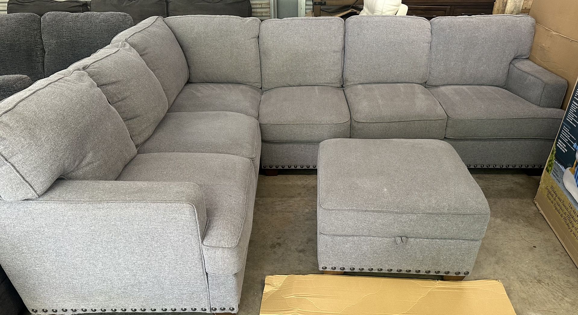 Thomasville Emilee Fabric Sectional with Storage Ottoman Floor model, still in great condition. Features: Color: Gray 100% Polyester Fabric Sinuous