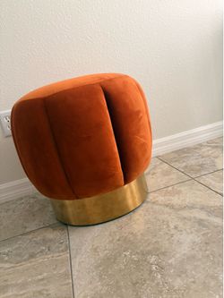 Orange velvet ottoman with gold base