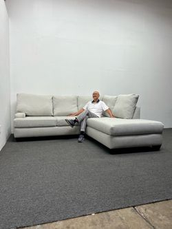 Living Spaces 2 pc Sectional couch with right arm facing corner Chaise. We deliver & setup.