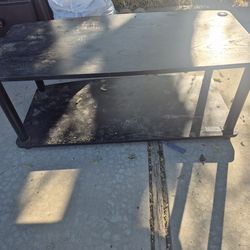 black, two-tier media console or audio-video storage rack.