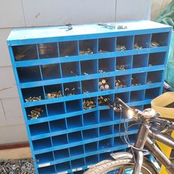 Fastenal The item shown is a metal industrial parts bin cabinet, specifically a blue 72-compartment pigeonhole bin unit, often used for organizing fas