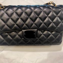 Quilted shoulder purse and gold hardware.