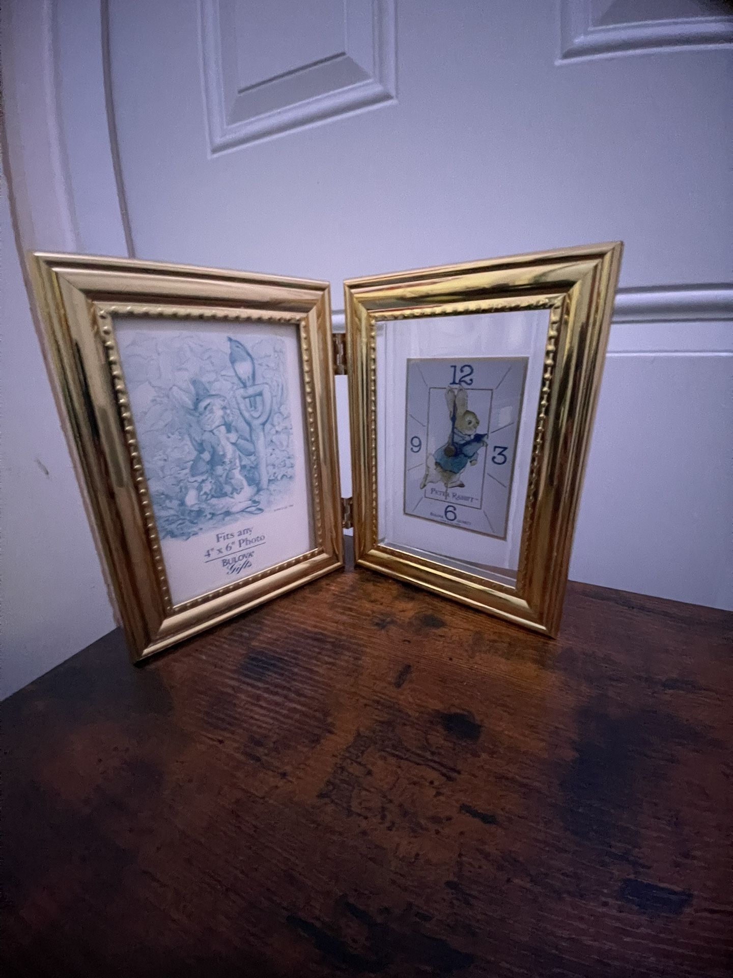 Bulova Peter Rabbit picture frame clock. It is a folding brass frame with a clock featuring the Peter Rabbit character.