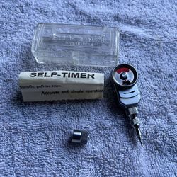 Kalt mechanical self timer for camera