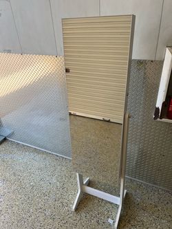 Mirror with jewelry storage