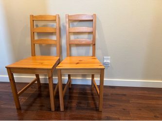 Two Ikea wood chairs