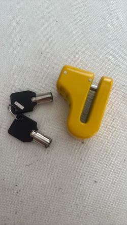This is a bright yellow NFI essentials disc brake lock designed for bikes and https://offerup.com/redirect/?o=bW90b3JjeWNsZXMuSXQ= features a heavy-du