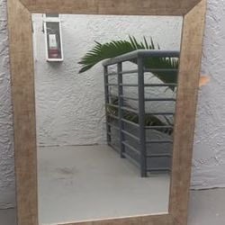 Rectangular wall mirror in gold toned frame