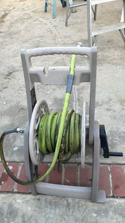 Water hose rollers with hose.