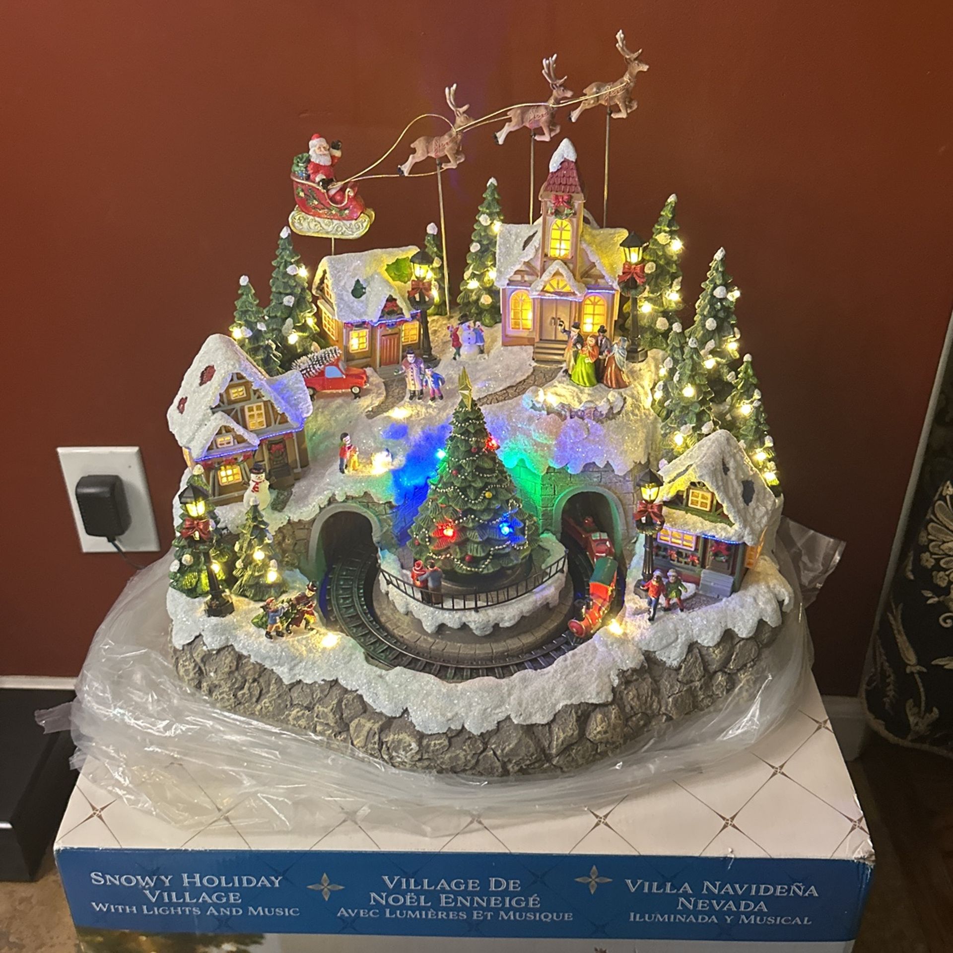 Snowy holiday village with lights and music (collectible)