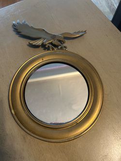 Beautiful vintage brass circular mirror with eagle at the top