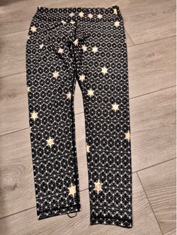 Fabletics black leggings geometric star pattern and gold stars Woman’s size M