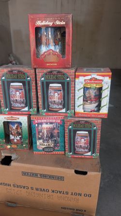 This collection features multiple vintage Budweiser Holiday Steins from various years, including the 1997 "Home for the Holidays"  7 items