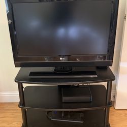 LG 32 Inch TV with remote, attached stand and entertainment unit 