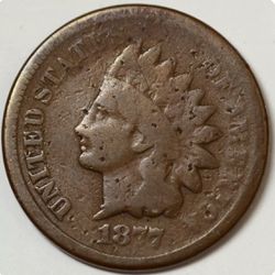 1877 Indian Head Penny in Good condition, key date and guaranteed genuine. Moderate wear across the design. Raw, original surfaces with some tiny, sha