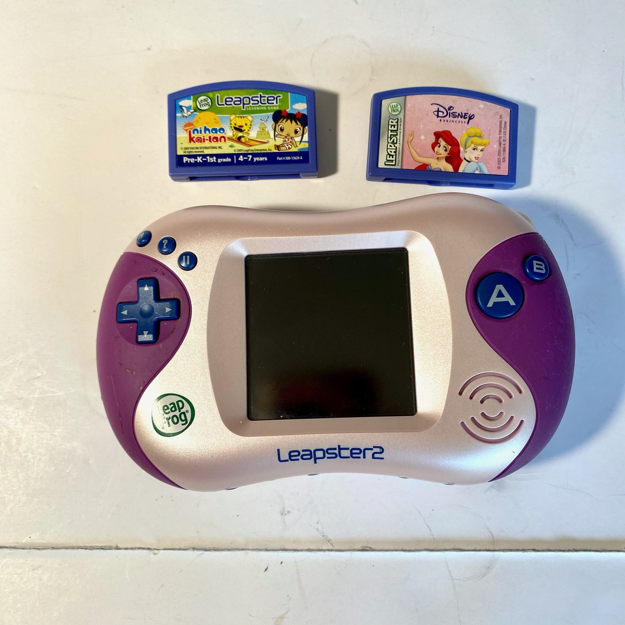 LEAPFROG LEAPSTER 2 PINK/PURPLE HANDHELD LEARNING GAME SYSTEM W/ 2 GAMES NI HAO KAI-LAN & DISNEY PRINCESS NO STYLUS