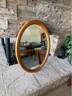 Vintage oval shaped light wood accent mirror